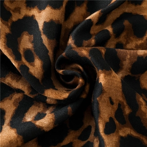 Macro shot of soft leopard print fabric with detailed texture and draped spiral design