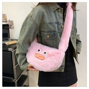 Pink plush crossbody bag with quirky doll face and signature sausage lips on a model