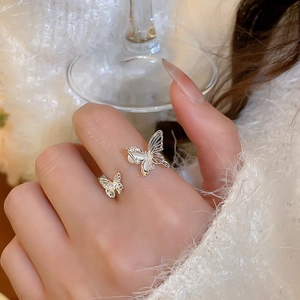 Detailed view of silver butterfly open ring with zircon and mother of pearl inlay