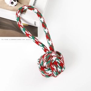 Macro view of Christmas red, green, and white woven cotton rope pet dog chew toy