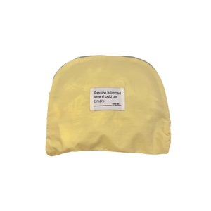 Waterproof yellow semicircular travel storage bag with zipper and passion quote label