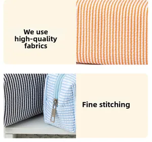 Detailed view of striped seersucker pouch with durable metal zipper and fine stitching