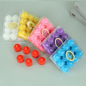 Assorted colorful unscented tea light candles in transparent boxes for home decor