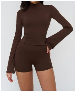 Close-up of slim-fit yoga jacket with flared sleeves and high-waisted fitness shorts