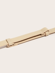 Detail view of cream Saffiano leather waist belt with sliding buckle and cross texture