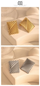 Detail showing the ribbed texture of geometric square metal earrings in gold and silver