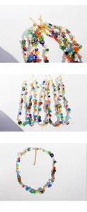 Detailed close-up of colorful glass flower beads and golden lobster clasp on the necklace