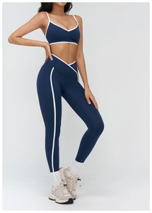 Detail of navy yoga set featuring white contrast trim and V-shaped crossover waistband