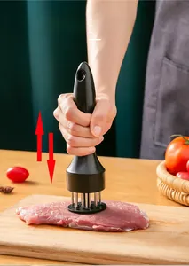 Detailed view of meat tenderizer needles penetrating raw steak on a wooden board