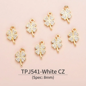 Detailed macro view of 8mm clover charm with white zircon in 18K gold plated copper