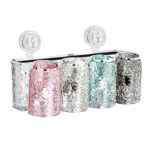 Wall-mounted toothbrush holder set with four colorful hammer-pattern cups and suction cups