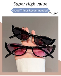 Detail view of cat-eye sunglasses featuring black and pink-purple gradient lenses