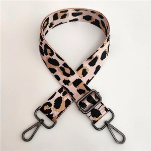Close-up of leopard print shoulder strap with adjustable metal buckle and dual hooks