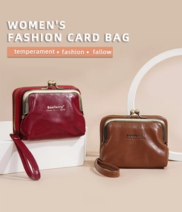 Detail of lychee textured leather wallets in dark red and brown with metal clasp closure