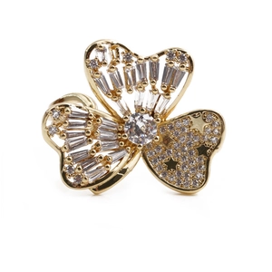 Adjustable gold flower ring with sparkling zircon stones in a top-down view on white background