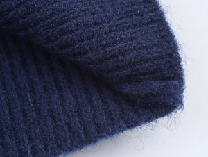Close-up of navy blue ribbed knit fabric showing soft mohair wool texture and fibers
