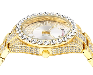 Macro shot of gold ice-out watch bezel with crystal inlay and Sunday date display