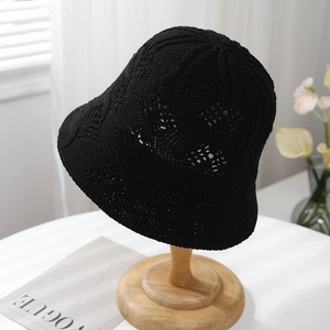 Close-up of black crochet knit bucket hat with intricate hollow texture and retro design