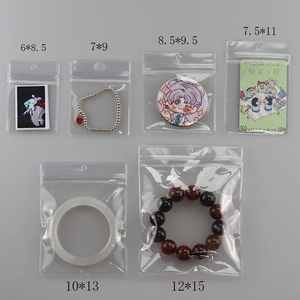 Flat lay of transparent PVC jewelry bags in six sizes from 6x8.5cm to 12x15cm for storage