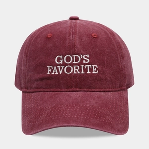 Detail of embroidered 'GOD'S FAVORITE' text on a vintage burgundy cotton baseball cap