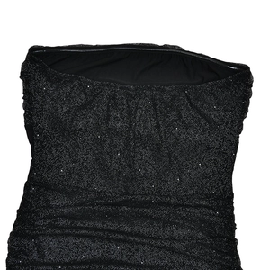 Detailed close-up of sparkling black sequins and pleated fabric on the strapless evening dress