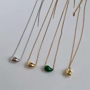 Polished stainless steel bean pendant necklaces in gold, silver, and emerald green finishes