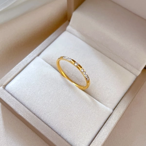Macro detail of gold-plated titanium steel ring with sparkling pave set diamonds