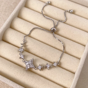 Macro shot of a silver star bracelet with sparkling zircon stones and adjustable bolo clasp