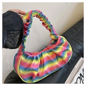 Close-up of rainbow gradient pleated cloud bag with soft ruched handle detail