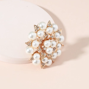 Exaggerated vintage flower ring in gold alloy with pearls and rhinestones on white base