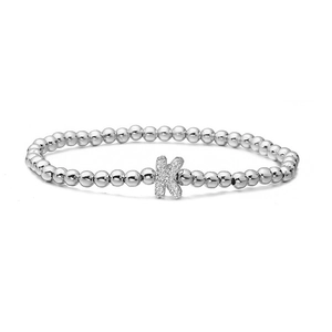 Macro shot of silver beaded bracelet with micro-paved cubic zirconia letter K charm