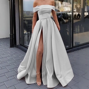 Elegant off-shoulder satin gown in silver with a high slit and a flowing A-line silhouette