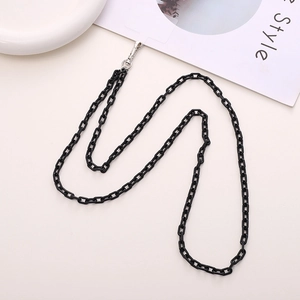 Crossbody black acrylic link phone chain with metal clasps on a stylish white setup