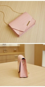 Detail view of pink crocodile pattern small square bag with elegant gold chain strap