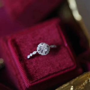 Vintage style adjustable floral ring with sparkling round cut diamond in a red velvet box