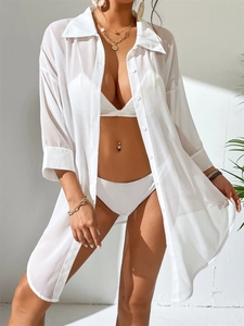 Detailed view of white chiffon beach cover-up shirt with elegant bikini and gold jewelry