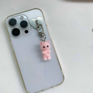 Close-up of pink flocked kitten charm with heart-shaped metal mount on a smartphone