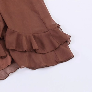 Brown chiffon maxi dress with layered ruffle hem and flowing bohemian silhouette