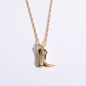Gold plated cowboy boot necklace on white background with creative western style pendant