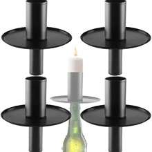 Detailed view of black metal candle holder inserts for bottles with one lit candle
