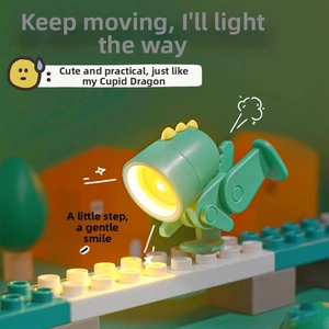 Mini dinosaur desk lamp with adjustable limbs and glowing LED head on colorful blocks