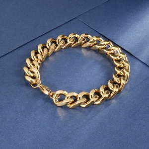 Macro detail of high-polish gold Cuban link bracelet with lobster clasp and secure links