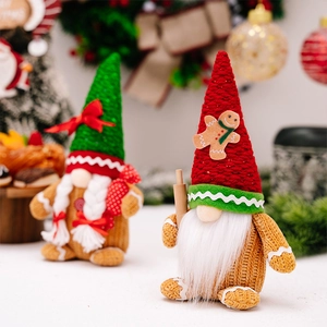 Close-up of Christmas gnomes with gingerbread motifs and candy bags in festive setting