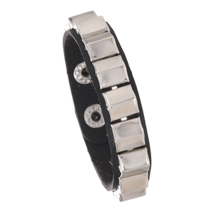 Detail of a punk leather bracelet set featuring silver square metallic studs and textures