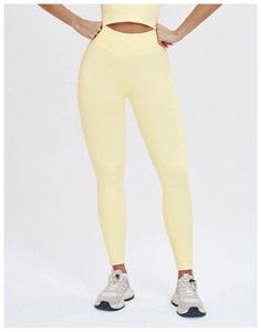 Detailed view of high-waisted ribbed waistband on light yellow seamless yoga leggings