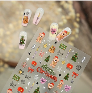 Detail of Christmas nail stickers featuring cute bears, trees, and festive patterns