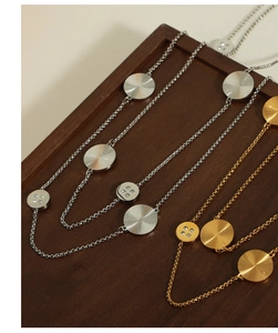 Detailed macro shot of vintage gold and silver pendant necklaces with sparkling rhinestones