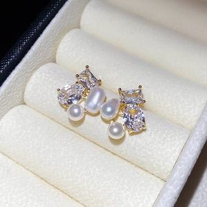 Elegant asymmetrical pearl firework stud earrings in gold with white zirconia stones