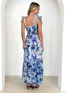 Detailed back view of a floral maxi dress with backless tie design and tiered skirt