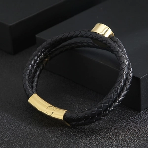 Detail view of double-layer woven black leather bracelet with a gold metal G-clasp